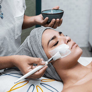 crop master applying mask on face of woman 2025 03 09 06 08 42 utc Beauty Salon in Hackettstown NJ: Discover Personalized Hair, Skin, and Beauty Care