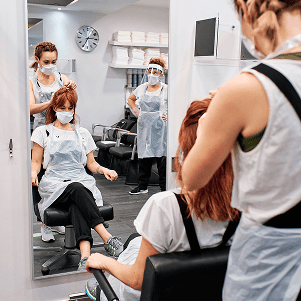 hairdresser in beauty salon with face mask to prot 2025 03 07 13 44 37 utc Luxury Hair Salon Hackettstown